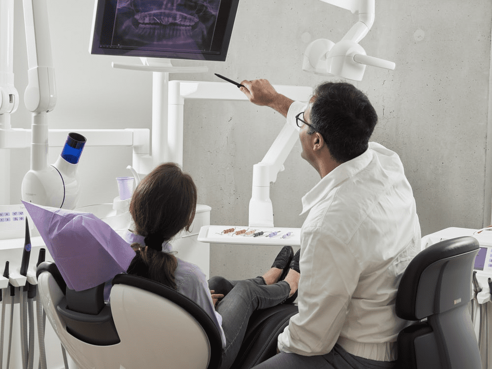 Dentist and dental patient looking at x-ray