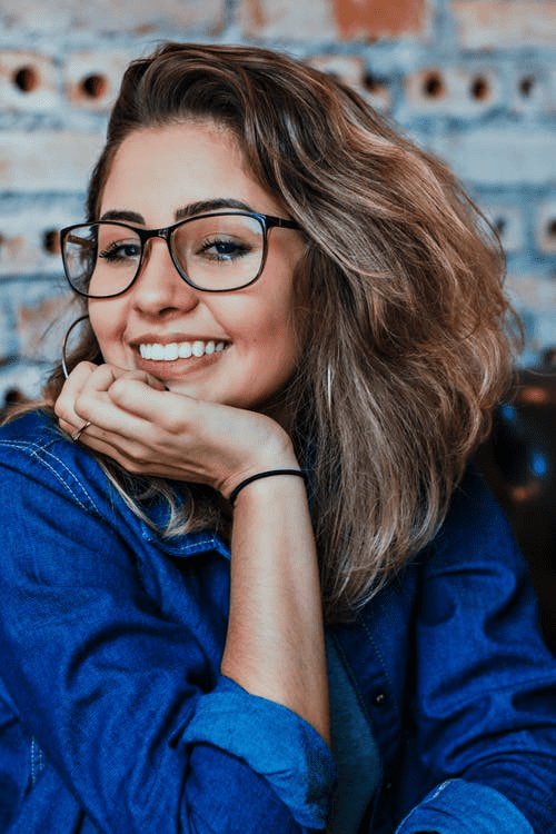 A smiling woman with glasses